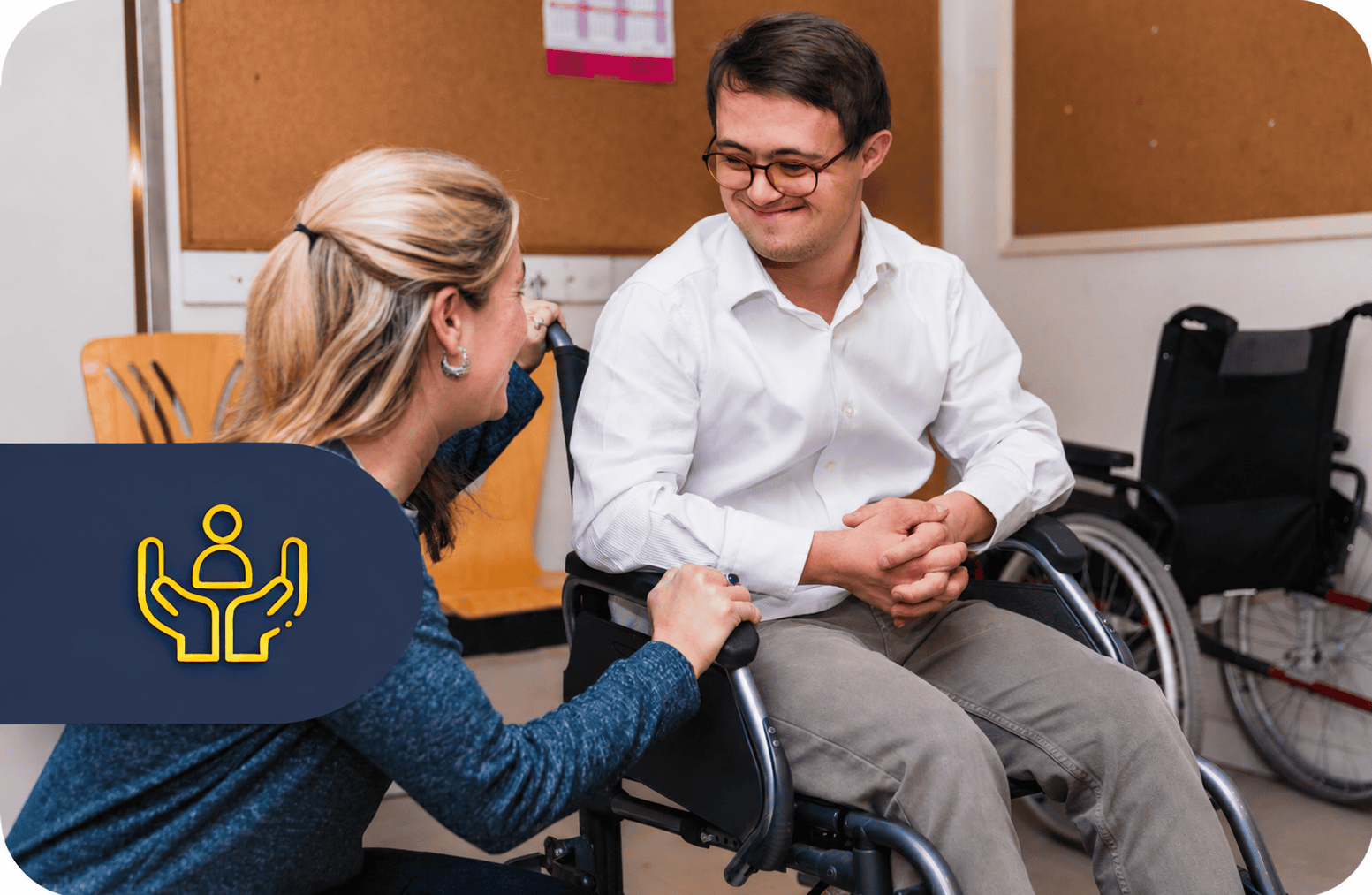 Caregiver talking with man in wheelchair
